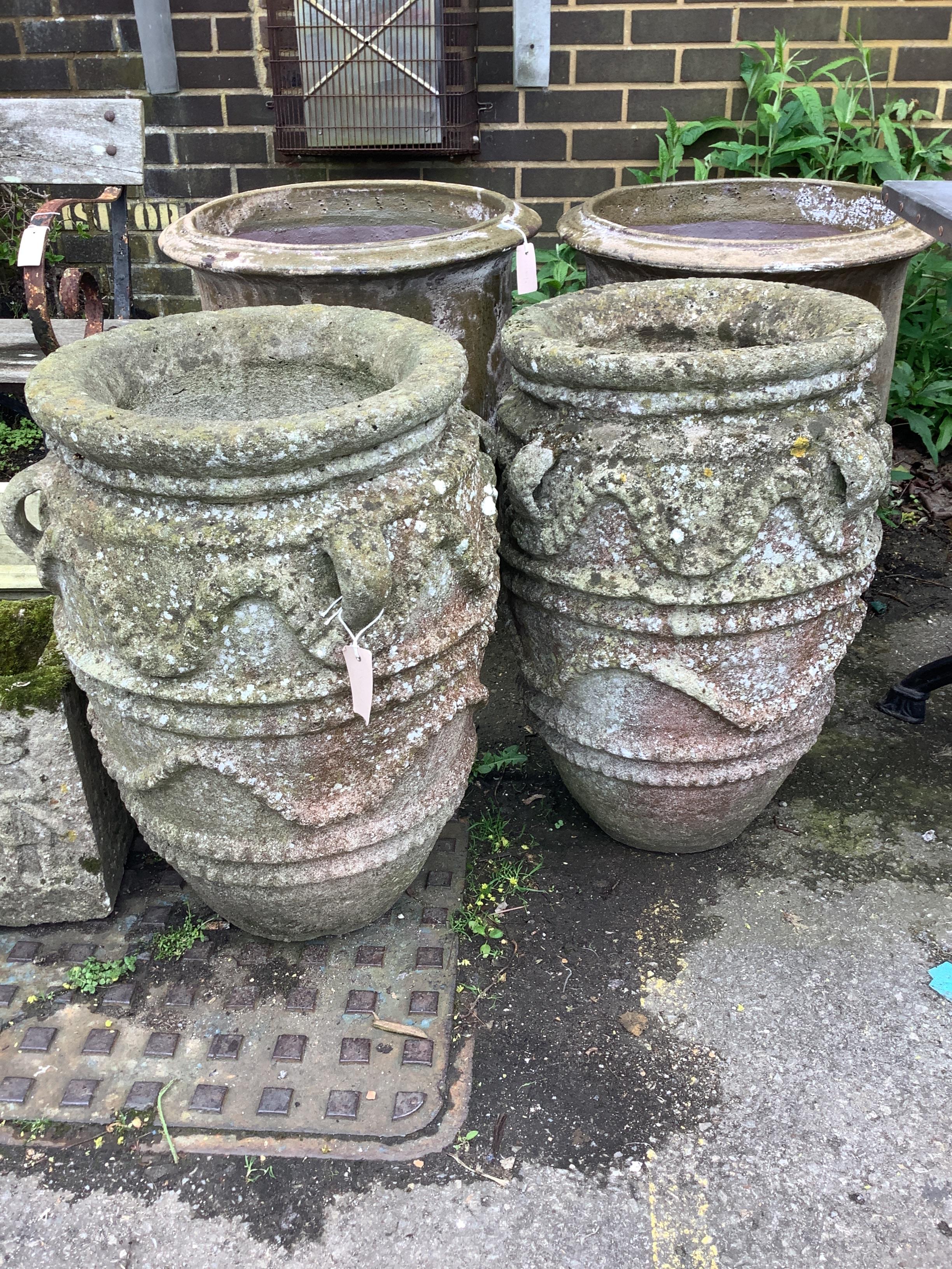 A pair of large reconstituted stone gardens urns with rope moulded bodies, diameter 44cm, height 63cm